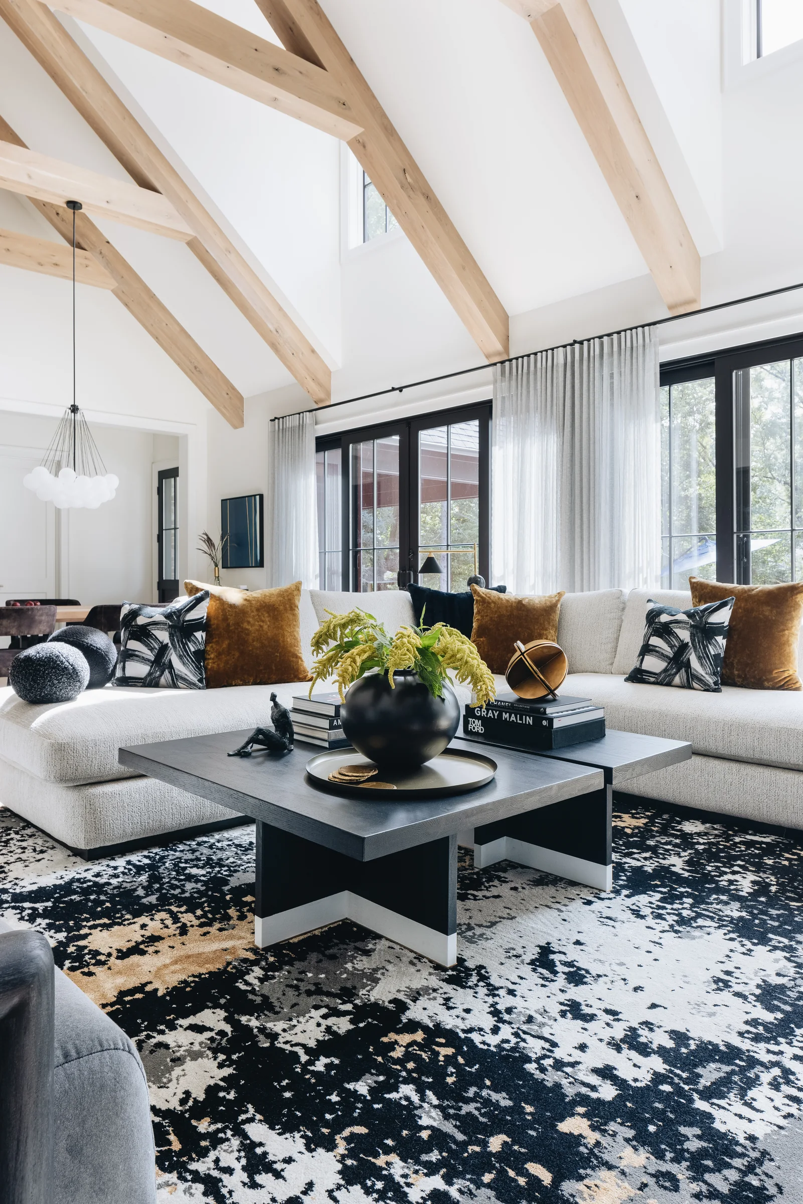 Dining room with exposed timber beams and sculptural lighting
